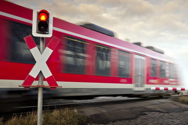 La luz roja del semáforo en el cruce de trenes