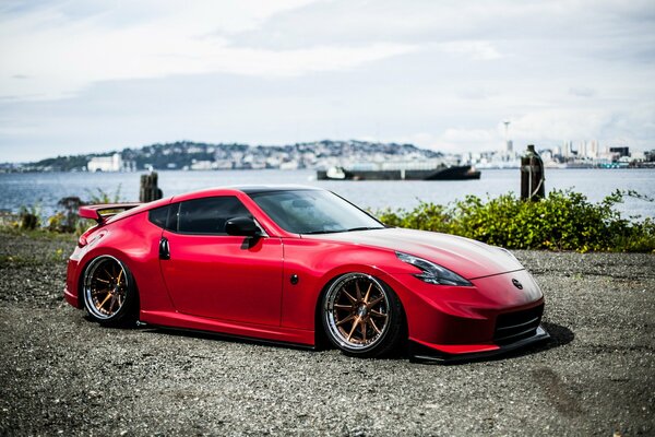 The zatuning red Nissan 370 Z is harmonious with nature