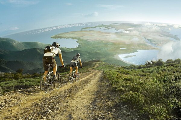 A married couple rides bicycles along green fields