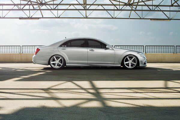 Profile of a white Mercedes car on the bridge