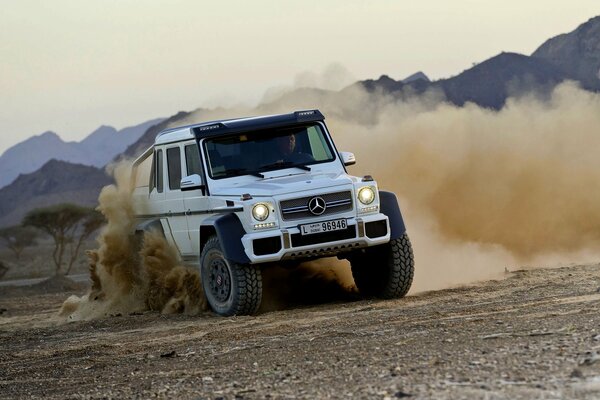 Mercedes Benz in a skid on a dirt road
