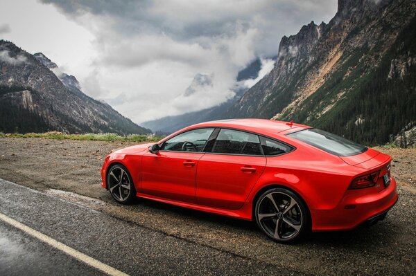 Red audi on the background of mountains