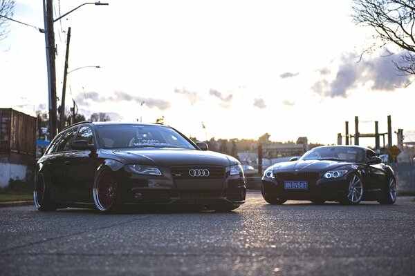 Two cars are located together against the background of a bright sky