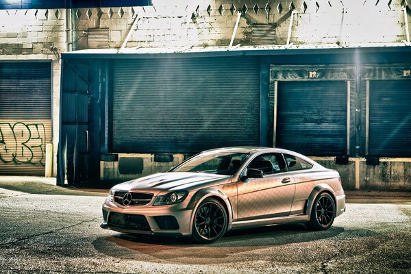 The Mercedes is parked in an abandoned neighborhood