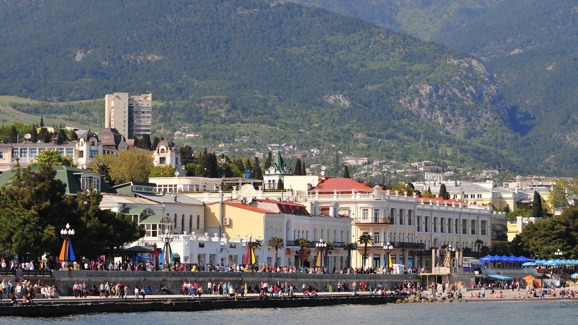 yalta mountains crimea promenade the city resort vacationers people home sea palm trees summer