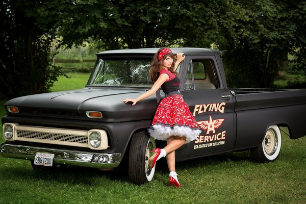 An old pickup truck next to a girl