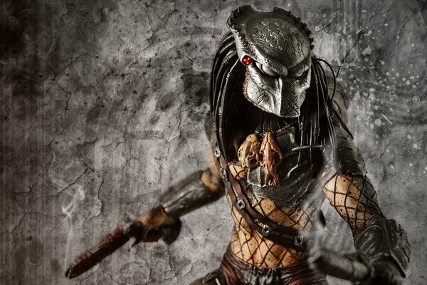 Predator from the movie with a gun in his hands