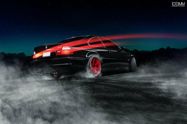 A black car drifts on the road