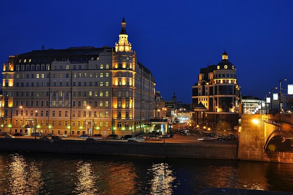 City embankment with a bridge and buildings