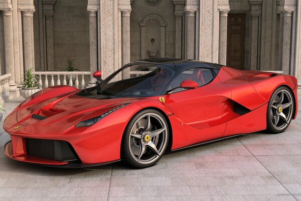 A red Ferrari car stands sideways against the background of the building