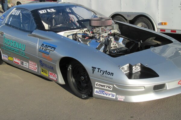 Silver corvette on the road with a transparent hood