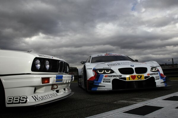 Racing cars under a grey sky