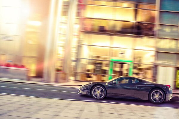 A black Ferrari driving through on a hot June day