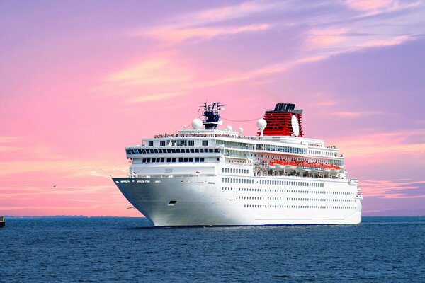 A ship on the background of the sunset sky