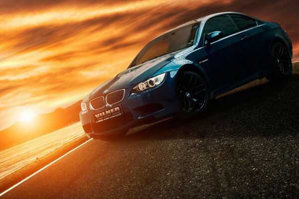 Black BMW meets a gorgeous sunset near the river