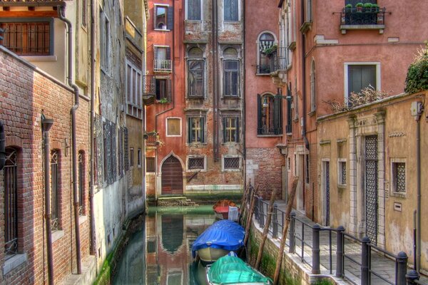 Standing gondolas in the waters of the Venetian streets