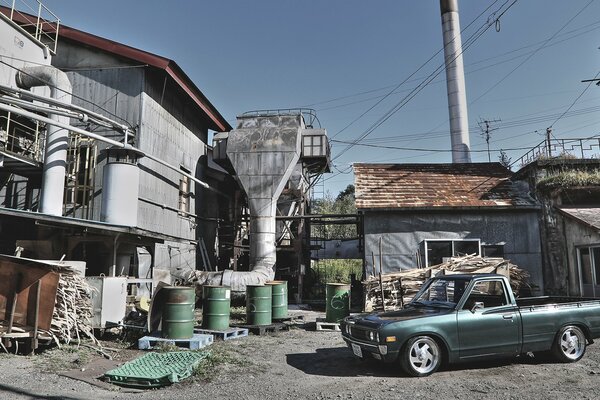 Datsun pickup truck near single-storey buildings