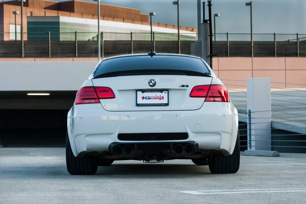 White BMW on the background of boring architecture