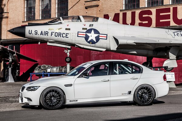 White car on the background of an airplane