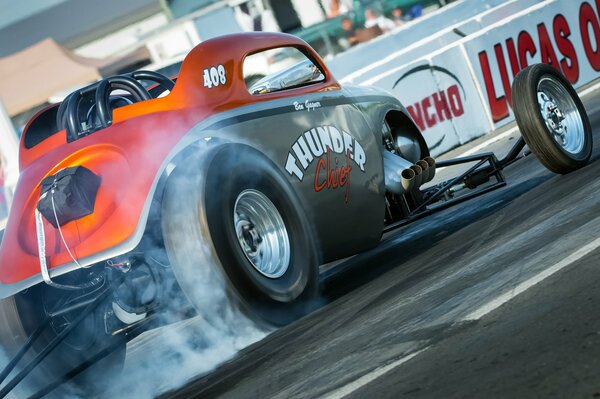 Smoke from under the wheels of a racing car