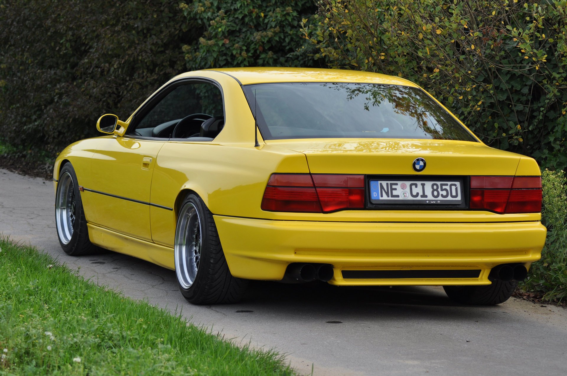 bmw 850 ci e31 bmw bmw coupe sports car yellow style design high-tech techno germany bavaria auto yellow car car car transport grass hedge greenery rear view foliage passenger cars motor transport