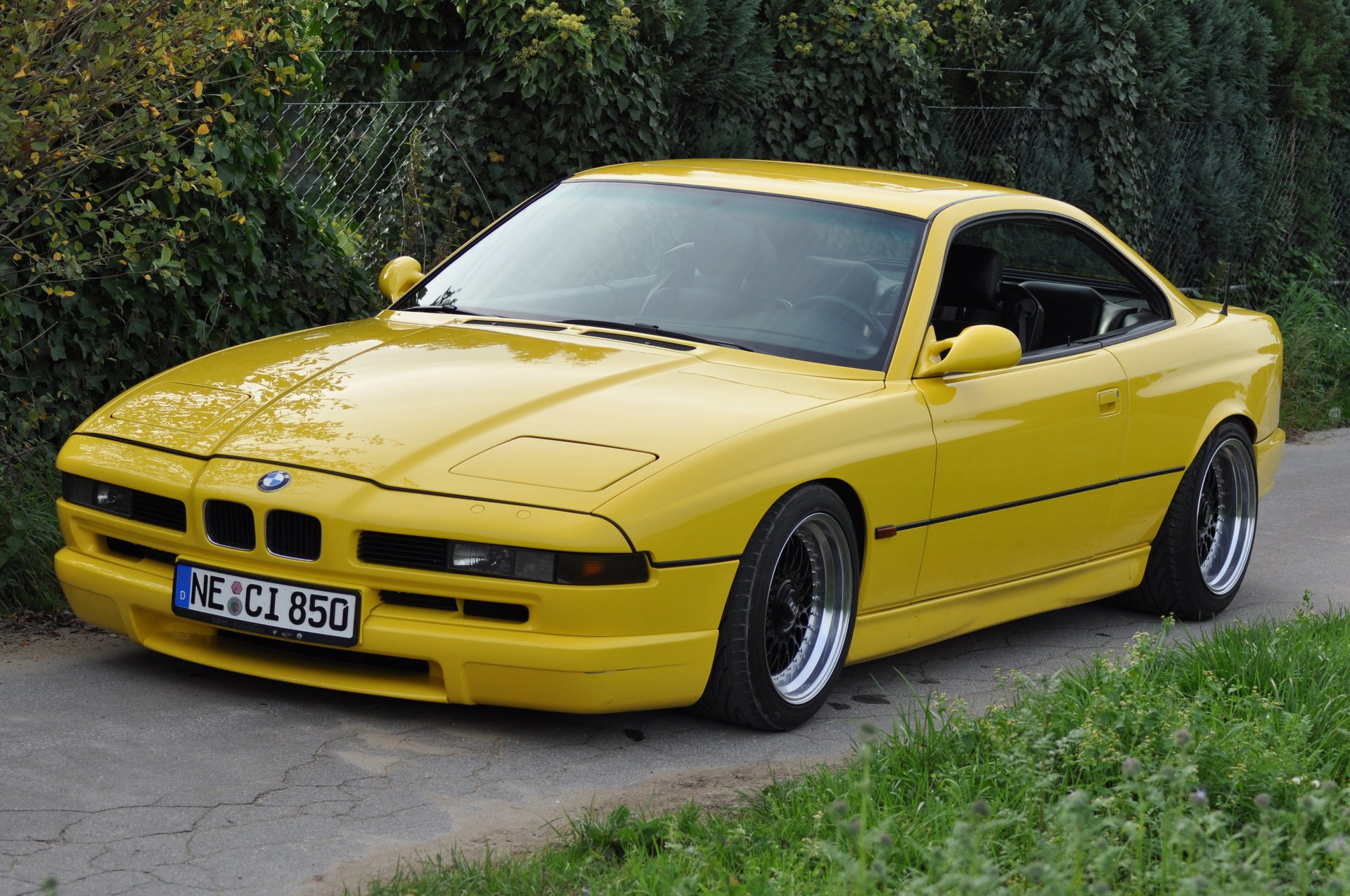 bmw 850 ci e31 bmw bmw coupe sports car yellow style design high-tech techno germany bavaria auto yellow car car car transport grass hedge greenery foliage passenger cars motor transport