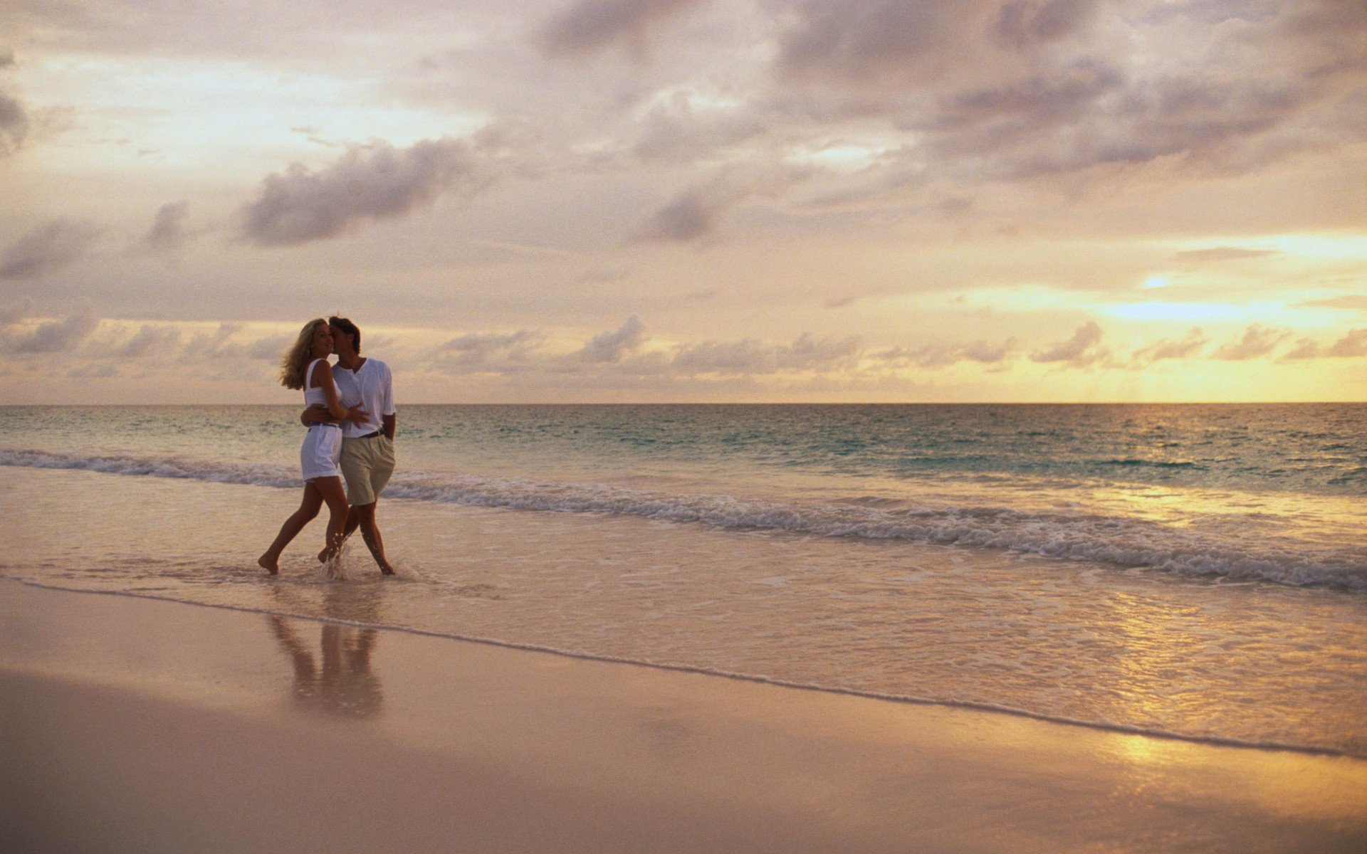 love romance pair lovers kiss hugs surf sea sunset horizon clouds the sky the evening tenderness wave beach shore coast