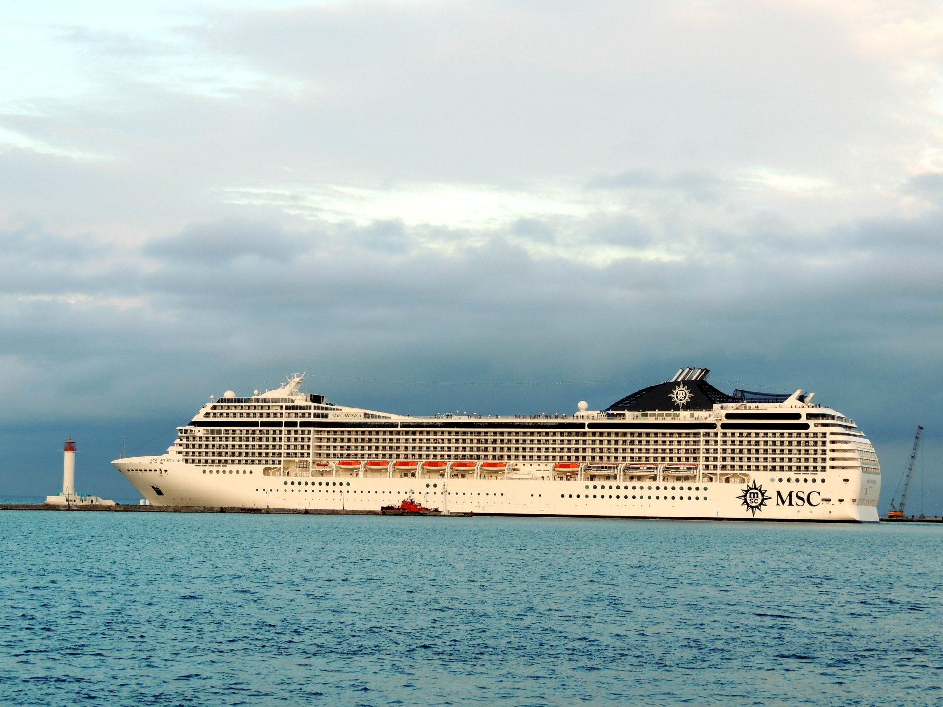 odessa the port msc musica cruise ship lift mole lighthouse sky cloud