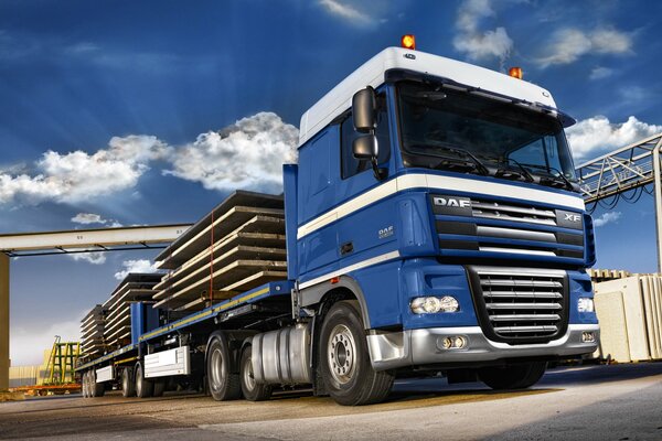 Blue daf long gauge with cargo on a blue sky background