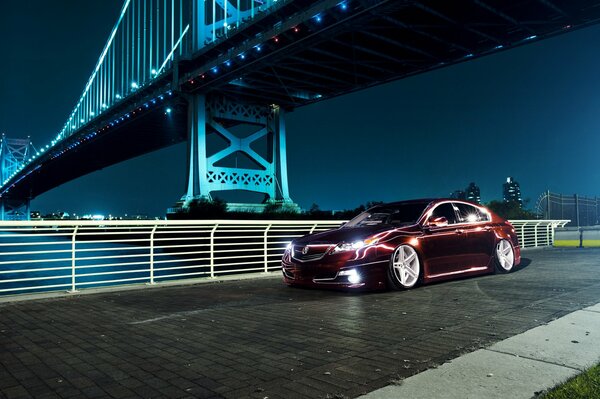 Honda in metallo vicino al ponte della città di notte
