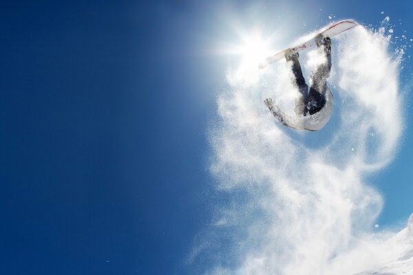 Snowboarding jump in snowy mountains