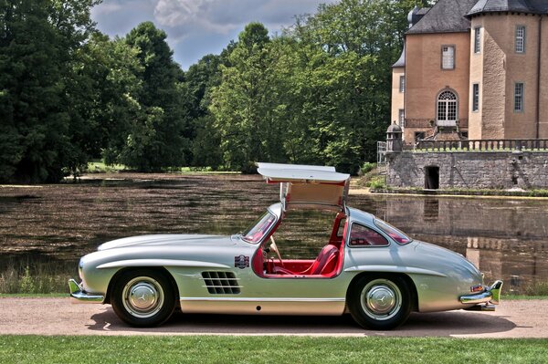 A rare silver Mercedes Benz with a red interior