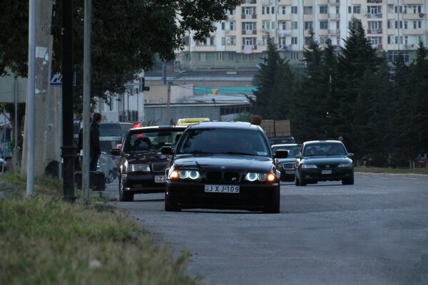 Black cars are driving on the road