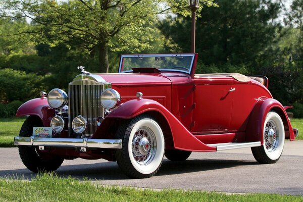 Red packard next to the trees