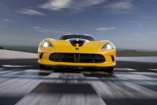 Dodge Viper supercar at speed with headlights on