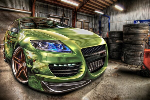 A green passenger car in the garage