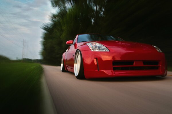High-speed movement of a stylish red Nissan