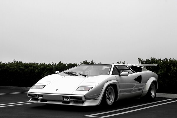 Supercar blanc et parking sous les nuages