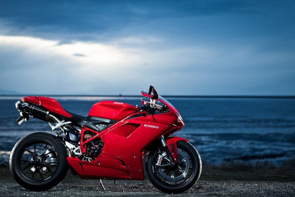 Red ducati motorcycle on the background of the sea