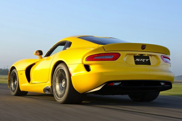 Picture of a driving yellow car viper gts