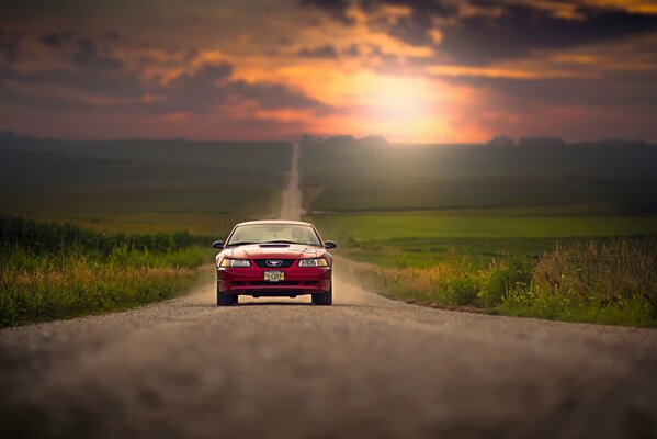 Ford mustang on the sunset road