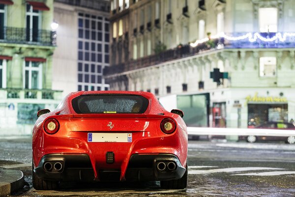 El coche rojo de Ferrari se encuentra en el fondo de los edificios