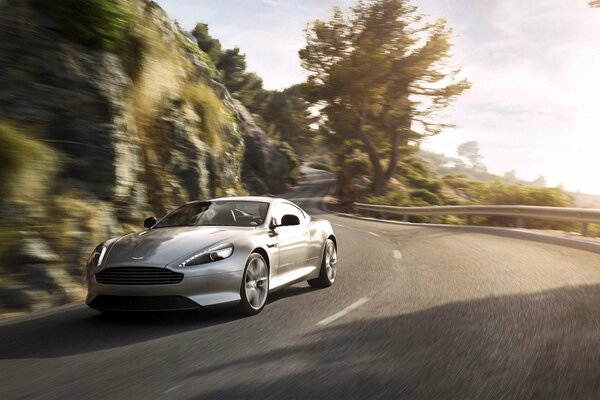 A beautiful silver car is driving on the road