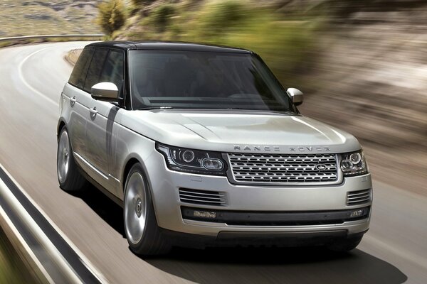 Land Rover rushes along the road in the direction of his dreams