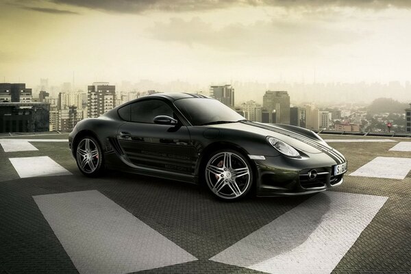 Black Porsche on the road with markings