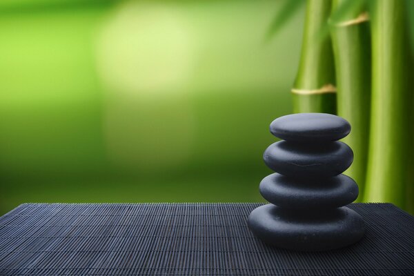 A pyramid of stones on a bamboo background