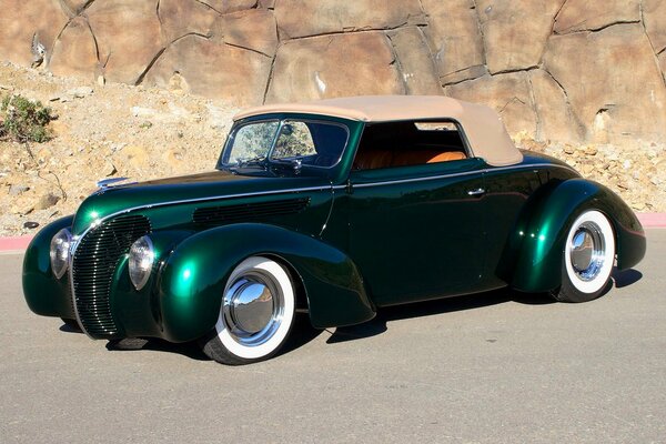 Retro car with a beautiful body in metallic green