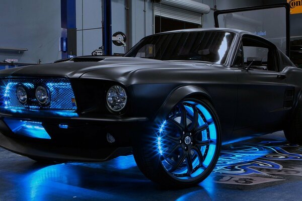 Shelby Mustang with neon lighting in the workshop