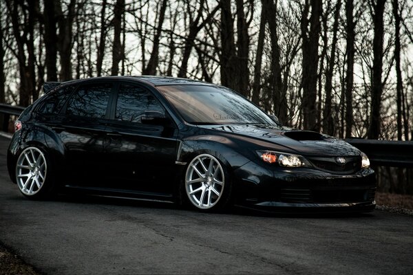 Subaru Impreza negro en el fondo de los árboles