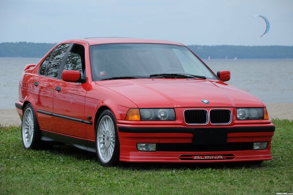 BMW car on the grass next to the water